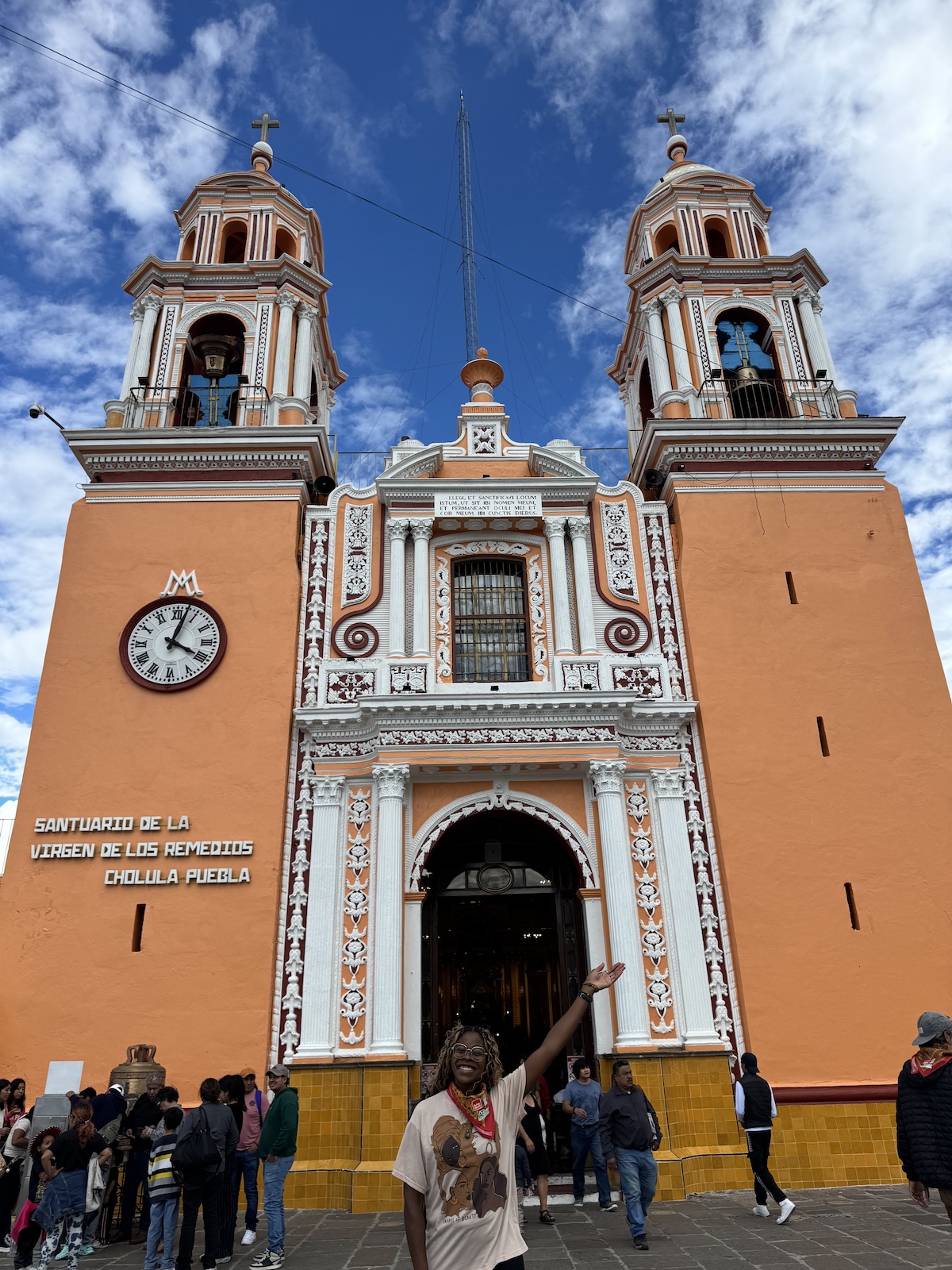 Me smiling in front of the Santuario de la Virgen de los Remedios.