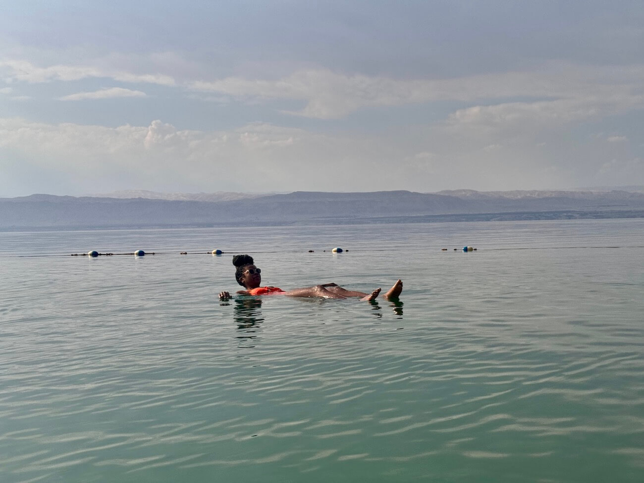 Photos of me relaxing and floating in the Dead Sea. This is one of the safest places to travel to Jordan!