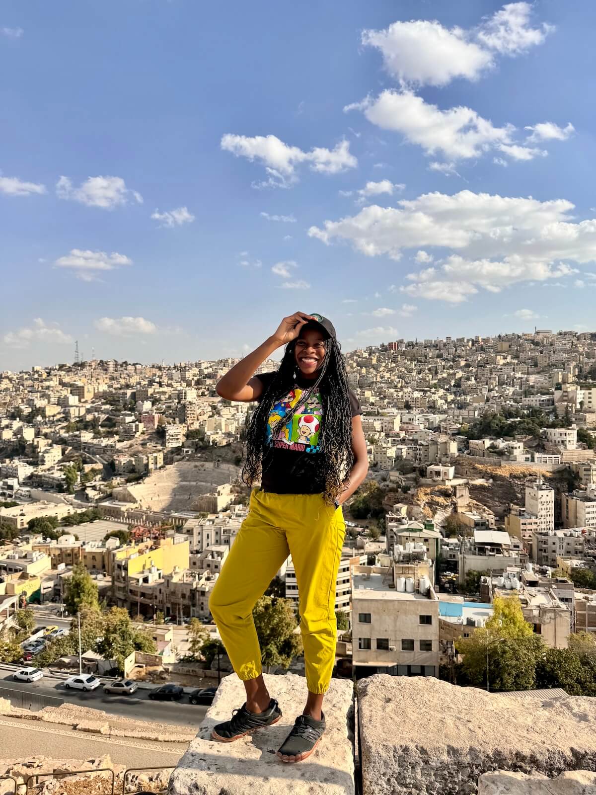 Photos of me standing and smiling while looking down at Amman. This photo shows that traveling to Jordan is safe.