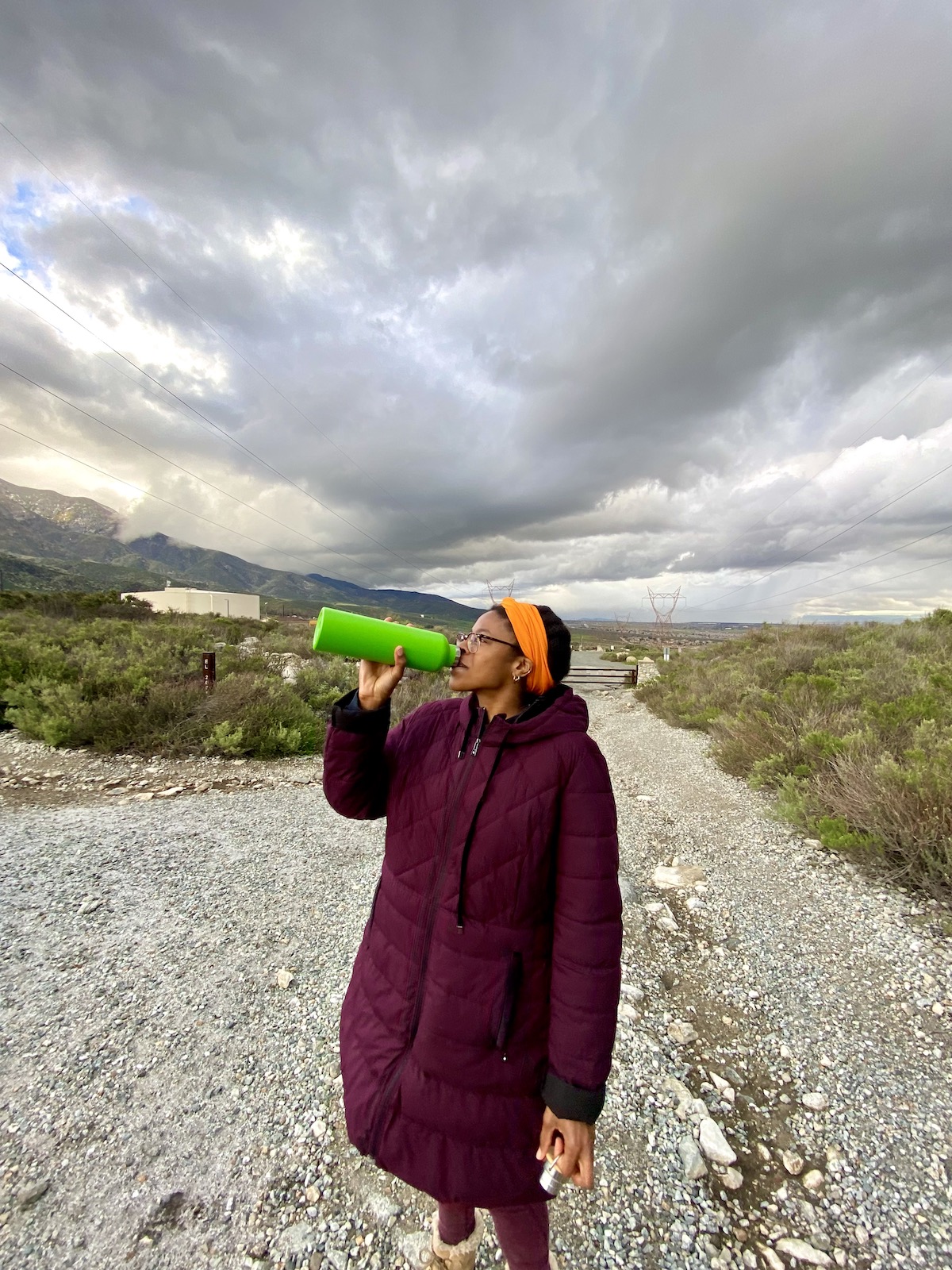 Me drinking from the green water bottle on a hike