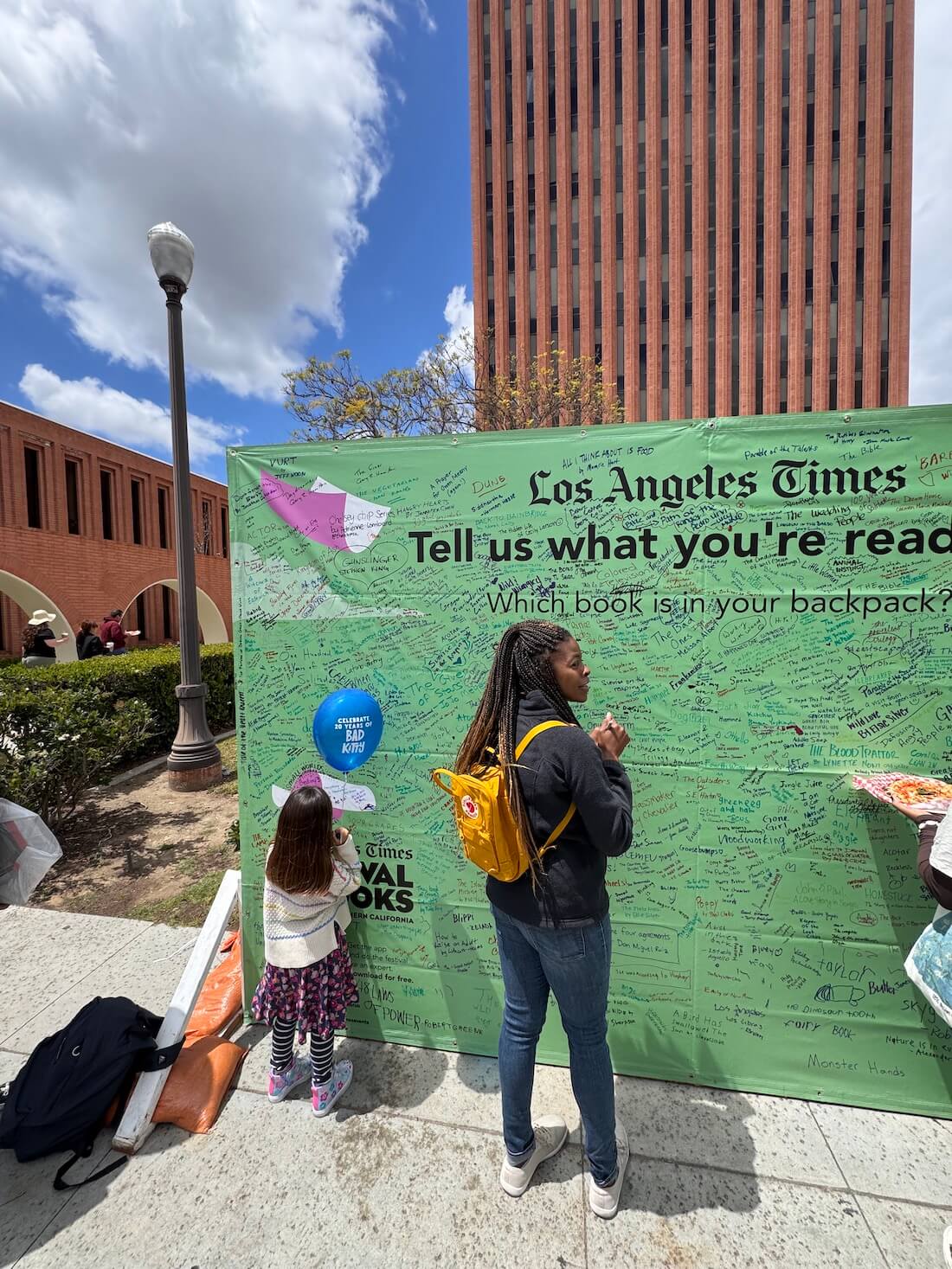 A photo of me writing on a reading wall at USC during the LA Times Book Festival.